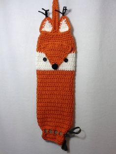 an orange and white crocheted animal head cover