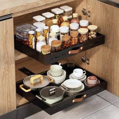 an open drawer in a kitchen filled with dishes