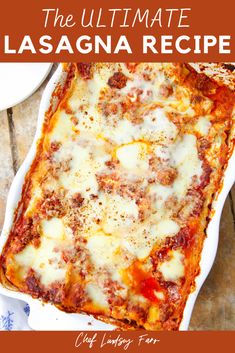 the ultimate lasagna recipe in a white casserole dish on a wooden table