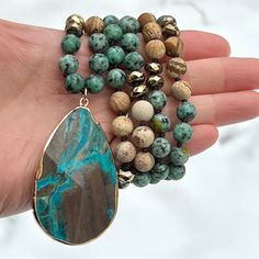 This necklace has a unique and striking beauty from three kinds of pure and high-grade Jasper with immense healing and nurturing benefits: Blue Ocean Jasper, African Jasper and Picture Jasper stones. Blue ocean jasper is among the popular jasper varieties you will come across. It bears orb-like nodules from silicic fluid forming in the circular nucleus cluster. These nodules fuse with sedimentary elements and create banded layers that give the gemstone its bewildering beauty. Ocean Jasper assist Spiritual Agate Turquoise Necklace For Healing, Spiritual Turquoise Agate Necklace For Healing, Healing Jasper Necklaces With Natural Stones, Healing Jasper Necklace With Natural Stones, Spiritual Turquoise Necklace With Agate Stones, Spiritual Turquoise Necklace With Natural Agate Stones, Healing Turquoise Agate Necklace, Spiritual Ocean Jasper Necklaces For Healing, Jasper Natural Stones Necklace For Meditation