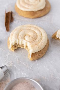 cinnamon cookies with white frosting and cinnamon sticks