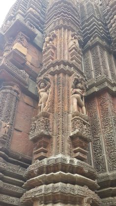 ornate carvings on the side of an old stone building with columns and pillars in india