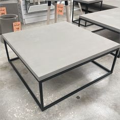 tables and chairs for sale in a store with price tags on them, including one table