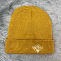 Manchester Bee Mustard Embroidered Beanie Hat Unisex | Etsy Cotton Beanie With Embroidered Logo, Yellow Cotton Beanie Hat, Beanie With Embroidered Logo, Embroidered Logo Beanie One Size Fits Most, Casual Beanie With Embroidered Logo, Embroidered Logo Beanie, Adjustable Beanie With Embroidered Logo, Yellow Beanie Cap For Winter, One Size Fits Most Beanie With Embroidered Logo