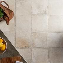 a kitchen counter top with bowls of fruit on it next to a cutting board and utensils