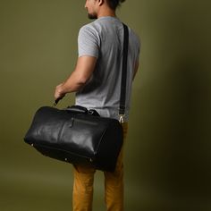 GUARANTEED CHRISTMAS DELIVERY ON ORDERS PLACED BEFORE THE 19TH OF DEC. This leather duffel bag seamlessly blends timeless elegance with durable functionality, making it the perfect companion for every occasion. Whether it's a quick getaway, a stylish weekend trip, or a visit to the gym, this versatile carry-on bag will go with you anywhere. Crafted from soft full-grain leather, reliable YKK Zipper and rust free antique brass fittings and studs, it exudes sophistication. With its optimal size, abundance of pockets, lightweight and flexible design, and a removable shoulder strap, this bag is an ideal choice for all your travel needs. DIMENSIONS-  Length: 51 cm/ 20 inches  Height: 28cm / 11 inches Depth:  28cm / 11 inches ► DELIVERY: Same Day Shipping.Free Express Delivery in 4-6 working days Black Leather Trim Duffle Bag For On-the-go, Luxury Black Duffle Bag With Leather Lining, Black Satchel Duffle Bag For Overnight Trips, Black Bags With Leather Trim For Overnight Trips, Black Shoulder Bag With Leather Handles For Overnight Trips, Black Duffle Bag With Leather Trim Satchel, Classic Black Travel Bag With Leather Trim, Black Leather Duffle Bag For Travel, Classic Black Shoulder Bag For Overnight Trips