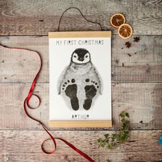 a card with an image of a baby's feet and the words, my first christmas