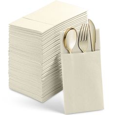 a stack of white napkins with gold forks and spoons