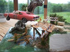 a toy car is on top of a wooden table in front of a fake tree