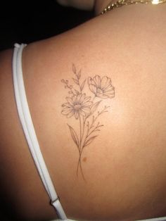 the back of a woman's shoulder with flowers on it