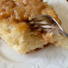 a close up of a piece of cake on a plate with a fork in it