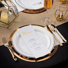 a table setting with gold and white place settings