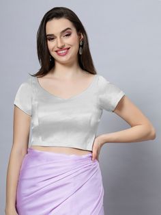 Our Satin Comfort Stretch collection blouses are made to impress and made to be worn all day. Made from the finest satin-cotton blend stretchable fabric, it holds its shape and shine while offering the comfort of stretchable material. Wear it with your favorite saree, as a crop top or lehenga choli! Item Type: Saree blouse / Crop top Product Features: Color: Silver Fabric: Satin Stretch Trim: Back Dori Neck Style: Leaf, Front & Back Sleeve Length: Short Closure: Back Hook Padded: No Occasion: Fe Cotton Stretch V-neck Blouse, Fitted V-neck Padded Blouse Crop Top, Fitted V-neck Crop Top With Padded Blouse, Fitted V-neck Crop Top With Padding, Fitted V-neck Padded Crop Top, Fitted V-neck Padded Blouse Top, Fitted V-neck Padded Blouse, Summer Satin V-neck Blouse, Fitted Padded V-neck Top