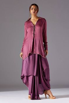 Rhubarb purple and plum purple kurta style shirt with hand embroidery. Comes with a draped cowl dhoti.
Components: 2
Pattern: Hand embroidered
Neckline: V Neck
Sleeve Type: Full
Fabric: Satin chiffon
Color: Purple
Other Details: 
Attached lining
Elasticated waistband on pant
Closure : Skirt - Side concealed zip
Occasion: Mehendi and Haldi,Sangeet - Aza Fashions Semi-stitched Purple Raw Silk Kurta, Purple Semi-stitched Raw Silk Kurta, Purple Silk Kurta For Party, Elegant Purple Raw Silk Kurta, Elegant Purple Straight Kurta, Purple Raw Silk Kurta With Traditional Drape, Elegant Purple Salwar Kameez With Traditional Drape, Silk Kurta With Dabka Work In Purple, Purple Straight Kurta With Sheer Dupatta