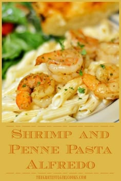 shrimp and penne pasta with alfredo sauce on a white plate next to a salad