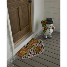 a door mat with a snowman on it and a potted plant next to it