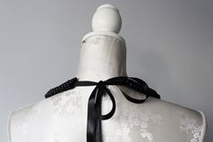 Handmade collar necklace with black pearls in different sizes. Peter pan collar style. Ribbon tied on the back. Adjustable to every neck size. Every single bead is handsewn. Collar gives a chic touch to simple dresses and blouses. One size. Handmade item. Wonderful gift for women or female friends. Please check out other items in my shop. You can find there collars in different shapes, colors and materials. Great to wear everyday and also for special occasions. Adjustable Black Pearl Necklace For Party, Elegant Black Pearl Necklace For Weddings, Beaded Black Pearl Necklace For Party, Black Beaded Pearl Necklace For Party, Black Pearl Evening Necklace, Black Pearl Necklace For Party, Black Beaded Pearl Necklace For Wedding, Elegant Bib Necklaces With Black Beads For Gifts, Elegant Bib Necklaces With Black Beads As A Gift