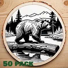 a wooden plaque with a bear walking across a river in the woods on it's side