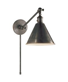 an old - fashioned wall light with a metal shade on the arm and a white background