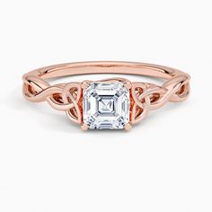 a rose gold ring with an emerald stone in the center