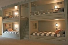 there are two bunk beds in this room with lights on the top and bottom bunk