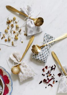 tea bags and gold spoons on a table