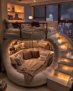 a spiral bed in the middle of a room with stairs leading up to it's second floor