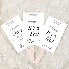 three cards with words on them are laying on a white surface and one has a pair of pink slippers in front of it