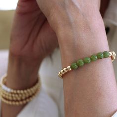 Elevate your style with the enchanting 14k Gold Filled 6mm Bead Bracelet with Jade, from our exquisite LEAHJESSICA Collection. Superior Quality: Features 14k gold-filled 6mm beads harmoniously paired with vibrant jade accents, ensuring both beauty and longevity. Versatile Design: Ideal for solo wear or as an elegant addition to any arm stack, this bracelet adds sophistication to any look. Comfort and Fit: Crafted with an elastic stretch for a snug and comfortable fit, while the lightweight desig Arm Stack, Connect With Nature, Gold Bead Bracelets, Bead Bracelet, Stretch Bracelet, Gold Beads, Beaded Bracelet, Gold Filled, Jade