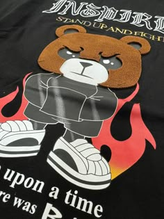 Unleash your inner strength with our "Inspired" Teddy Bear Graphic Tee. This unique graphic tee features a fierce teddy bear and bold lettering that reads 'inspired' and 'stand up and fight.' Made with quality materials, this tee will surely inspire you to take on any challenge with confidence. 95% Cotton, 5% Spandex Machine wash cold, Tumble dry low, Wash with like colors, Do not bleach. Imported B4KS486 Size Chart Size S M L XL XXL Chest (inches) 37.0 - 39.0 39.0 - 40.5 40.5 - 42.0 42.0 - 44.0 Affordable Casual T-shirt With Bear Design, Teddy Bear Graphic, Bear Graphic Tee, Bear Fashion, Evil Skull Tattoo, Kate Davis, Evil Skull, Teddy Bear Design, Bold Lettering