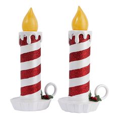 two red and white candle holders with lights on them, one is shaped like a candy cane