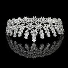 Floral CZ Bridal Tiara This stunning cz tiara will add a regal look to your wedding or quinceanera ensemble. The brilliant round, marquise and teardrop cz crystals are beautifully arranged in a multi peak floral design that will be perfect for your special day. The silver plated ear to ear design design glistens with high quality cz crystals, providing sparkle from every angle. A gorgeous headpiece for your wedding or quinceanera! Color: Silver/Clear. Style: hp7597. Size: Design is about 2 1/3" Quinceanera Tiaras, Crystal Wedding Tiaras, Crystal Bridal Tiaras, Regal Design, Tiara Crown, Bling Wedding, Bridal Look, Wedding Tiara, Bridal Crown