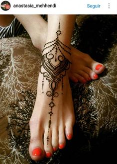 a woman's foot with a henna tattoo on it