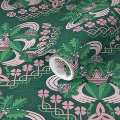 a green and pink wallpaper with an intricate design on it's surface,