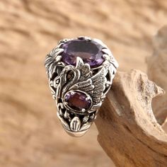 Faceted amethyst sparkles in a finely detailed ring by Kadek Hendra. Depicting graceful swans the ornate design showcases 3.9 gemstone carats. .925 Sterling silver Topaz Birthstone Ring, Swan Ring, Swan Jewelry, Amethyst Cocktail Ring, Topaz Birthstone, Amethyst Set, Unusual Rings, Pretty Jewelry, Wrapped Jewelry