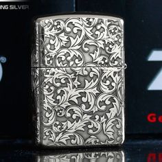 a silver flask lighter sitting on top of a table