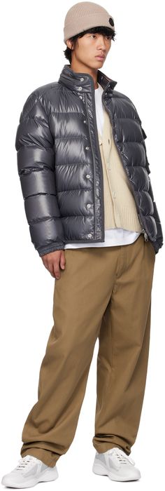 DIST-certified down-filled quilted polyester satin jacket. Webbing trim throughout. · Stowaway hood at stand collar · Two-way zip closure with press-stud placket · Zip pockets · Bungee-style drawstring at hem · Saddle shoulders · Flap pocket and felted logo patch at sleeve · Elasticized cuffs · Zip pocket at interior · Full quilted satin lining Supplier color: Magnet Fill: 90% goose down, 10% feather. Luxury Down Outerwear With Pockets, Luxury Duck Down Outerwear With Detachable Hood, Designer Hooded Puffer Jacket With Padded Collar, Designer Down Puffer Jacket With Detachable Hood, Luxury Duck Down Outerwear With Padded Collar, Designer Quilted Down Puffer Jacket, Luxury Down Outerwear With Double-lined Hood, Luxury Duck Down Puffer Jacket With Padded Collar, Designer Puffer Outdoor Outerwear