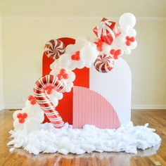 a large candy cane and balloon arch on the floor