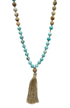 Show off boho-chic style in this long necklace composed of mixed beads in earthy hues with a tassel pendant. 38" length; 3 1/2" pendant 14k-gold plated brass/glass Imported Bohemian Tassel Necklace With Dangling Beads For Beach, Adjustable Beaded Long Tassel Necklace, Bohemian Long Tassel Necklace With Dangling Beads, Turquoise Bohemian Tassel Necklace, Adjustable Bohemian Long Necklace With Tassels, Adjustable Long Tassel Necklace With Dangling Beads, Bohemian Lariat Necklace With Tassels For Gifts, Bohemian Lariat Necklace With Tassels As Gift, Bohemian Long Necklace With Tassels