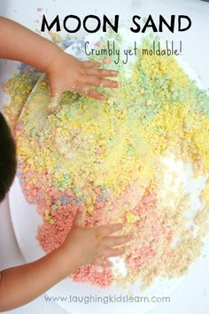 a child is playing with colored sand on the table and it says moon sand crumbly yet moldable