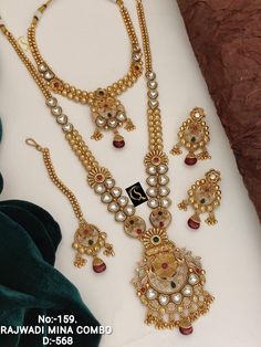 Description :- Antique Gold Plated Indian Jewelry Set, Indian Choker, Ruby Choker Necklace Set, Guttapusalu Necklace, Temple Jewelry, South Indian Jewelry Gift yourself a royal look with this perfectly crafted kundan necklace set from Manalisstudio. Crafted with high quality kundan stones and pearls, it is impressive in design. The green enamel artwork adds perfect texture to the design. Perfect for weddings and festivities, this antique necklace set should be put on with your favorite sari or l Kundan Jewellery Set Necklaces, South Indian Gold Necklace Designs, Ruby Choker Necklace, Ruby Choker, Guttapusalu Necklace, Indian Gold Necklace Designs, Indian Jewelry Set, Wedding Jewelry Sets Bridal Jewellery, Indian Choker