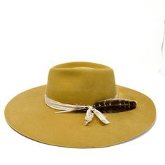 Lite stockman stiff felt, wide brim fedora in a gorgeous marigold color trimmed with vintage cream silk and a turkey tail feather. there is no stretch and little movement to this felt so please size accordingly. Made in the USA. Add "custom embroidery" to make it more personal. sm 21-22 inch circ md 22-23 inch circ lg 23-24 inch circ Bohemian Fur Felt Fedora Hat, Bohemian Fur Felt Fedora, Bohemian Wide Brim Fur Felt Hat, Yellow Curved Brim Fedora For Kentucky Derby, Bohemian Wide Brim Fur Felt Fedora, Bohemian Fur Felt Fedora With Wide Brim, Yellow Wide Brim Fedora, Yellow Brimmed Fedora For Kentucky Derby, Yellow Fedora For Kentucky Derby