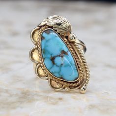 Vintage 14k gold and turquoise Navajo ring by the maker Ivan V. Era: c.1970s Markings: IVAN V 14k Materials: 14k gold, turquoise Ring Size: 7 1/4 (Comes with one free resizing by our jeweler) Face measures 2 3/4 cm in length Weight: 6.5 grams Condition: Excellent vintage condition with minor surface wear from age  Shipping is free in the United States Follow us on Instagram @LUXXORVintage Gold Turquoise Ring, Navajo Ring, Hudson Ny, Gem Jewelry, Navajo Rings, Vintage Navajo, Gems Jewelry, Rings Statement, Turquoise Ring