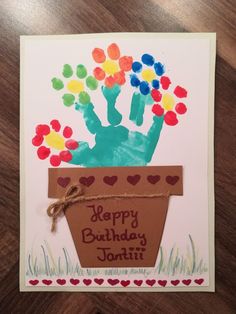 a handprinted happy birthday card with flowers in a pot