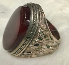 This ring is an estate sale find A stunning statement piece! It is not Marked but I had a Jeweler test it and he confirmed it is silver There is a beautiful oval large carnelian stone The silver is Embossed with birds and flowers on one side and what appears to be an arrow on the other. The ring Weighs  17 grams  with the Stone The size is about 10 1/4 I offer free shipping in the United States  all sales are final Unique Oval Engraved Ring With Gemstone, Unique Engraved Oval Ring With Gemstone, Vintage Silver Oval Signet Ring, Unique Oval Engraved Ring With Polished Finish, Unique Oval Signet Ring Collectible, Vintage Silver Ring With Large Stone, Vintage Round Rings With Large Stone, Vintage Silver Engraved Oval Ring, Vintage Oval Signet Ring Stamped 925