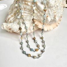 This necklace is the perfect way to bring summer serenity to any look. The amazonite beads evoke the natural beauty of a sandy beach and the peaceful rolling of the ocean. Let its calming energy help you find balance and harmony wherever you go. Beautifully wrapped with oxidized silver wire. It can be worn as wrap bracelet as well. Length 33.5" Known as the “hope” stone, the Amazonite is an excellent manifestation tool. Embracing the fluid energy of water, this stone guides you to overcome setba Single Strand Amazonite Spiritual Beaded Necklace, Amazonite Necklace With 108 Round Beads, Bohemian Amazonite Single Strand Beaded Necklace, Bohemian Amazonite Single Strand Jewelry, Bohemian Single Strand Amazonite Jewelry, Amazonite Gemstone Beads Necklace For Meditation, Amazonite Crystal Necklace With Round Beads, Amazonite Crystal Necklace With Round Natural Stones, Amazonite Necklace