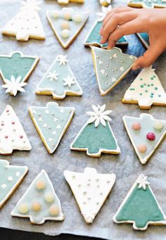 someone decorating decorated cookies on a table