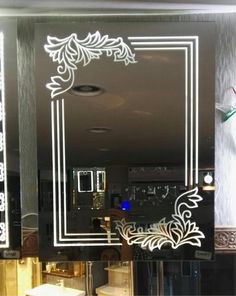 a bathroom mirror with an ornate design on it