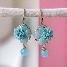 Introducing our stunning Blue Floral 3D Earrings, perfect for adding a touch of ethnic charm to your jewelry collection. Handcrafted with exquisite attention to detail, these earrings feature vibrant blue floral patterns that truly make a statement. These earrings boast a unique three-dimensional effect that adds depth and dimension to your ensemble. The hypoallergenic design ensures comfortable wear for even the most sensitive ears, making them an ideal choice for everyday use. Whether you're attending a special event or simply want to elevate your casual look, these ethnic-style earrings effortlessly complement any outfit. The beautiful blue floral motif captures the essence of traditional craftsmanship, while the modern 3D design brings a contemporary twist. Flower-shaped Nickel-free Earrings For Mother's Day, Nickel-free Flower-shaped Earrings For Mother's Day, Nickel Free Flower Shaped Earrings For Mother's Day, Blue Flower Charm Drop Earrings, Blue Drop Earrings With Flower Charm, Elegant Blue Drop Earrings With Flower Charm, Mother's Day Nickel Free Dangle Flower Earrings, Mother's Day Nickel-free Dangle Flower Earrings, Mother's Day Flower Shaped Jewelry With Matching Earrings