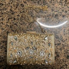 Bejeweled Chain Clutch, Brand New Practically, Used Once, Perfect For The Upcoming Homecoming Season! Embellished Metal Jewelry For Formal Occasions, Formal Embellished Metal Jewelry, Elegant Embellished Jewelry For Events, Formal Embellished Gold Jewelry, Formal Gold Embellished Jewelry, Glamorous Embellished Gold Jewelry, Glamorous Gold Embellished Jewelry, Elegant Embellished Evening Jewelry, Gold Embellished Jewelry For Formal Occasions